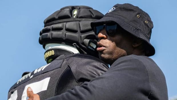 Deion Sanders hugging player in practice